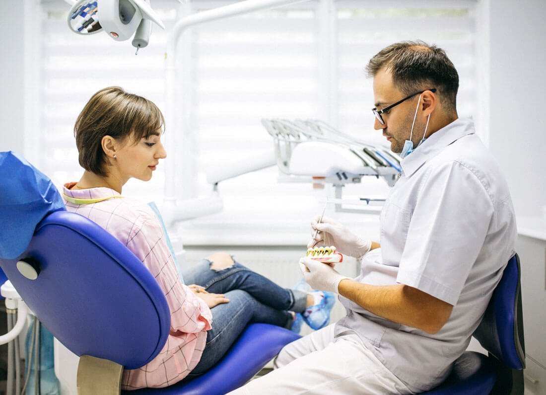 Dentist explaining treatment to a patient during a dental checkup in Lowell, MA