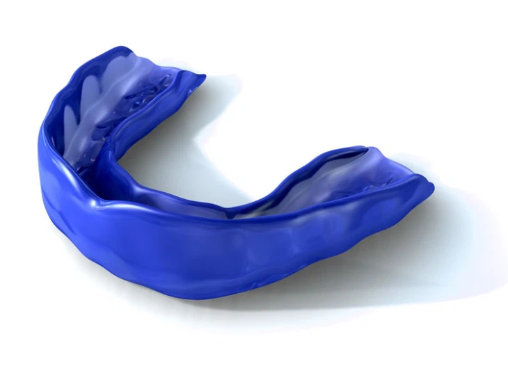 Blue custom sports mouth guard protecting teeth during athletics